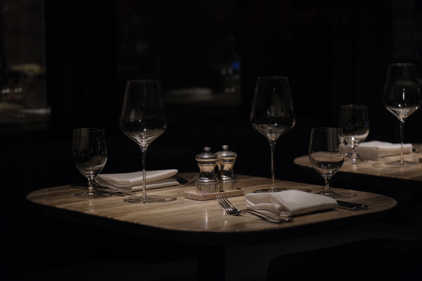 Fine dining table set in a dark restaurant